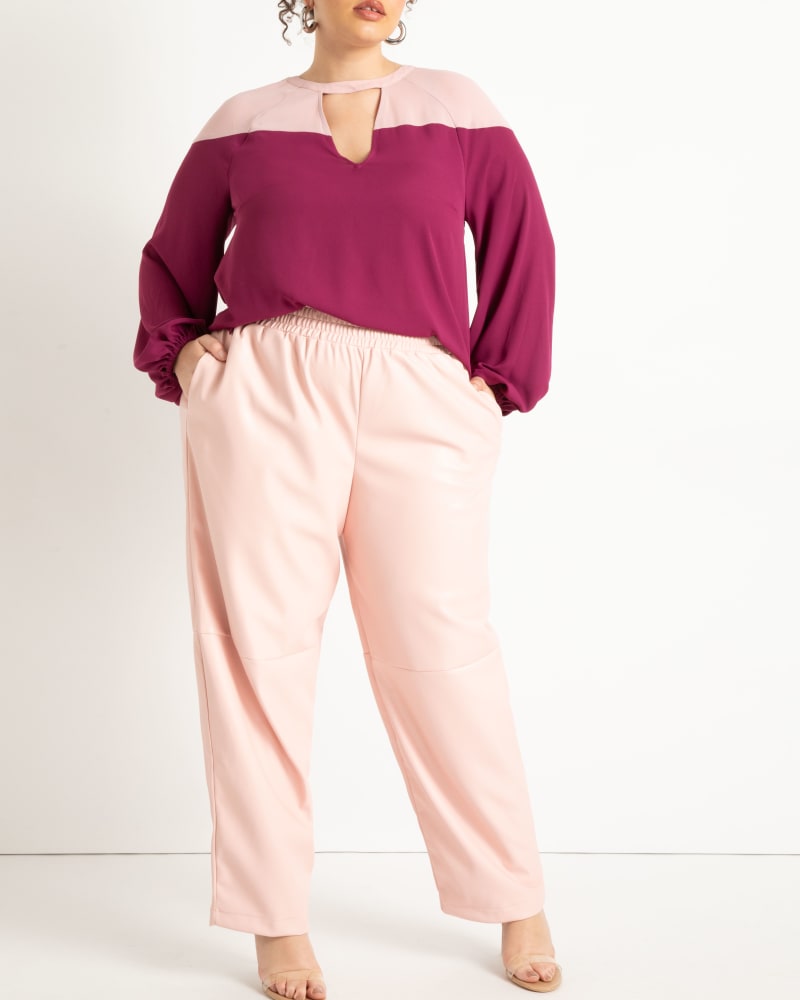Front of a model wearing a size 22 Faux Leather Pull On Pant in Peachskin by ELOQUII. | dia_product_style_image_id:272790